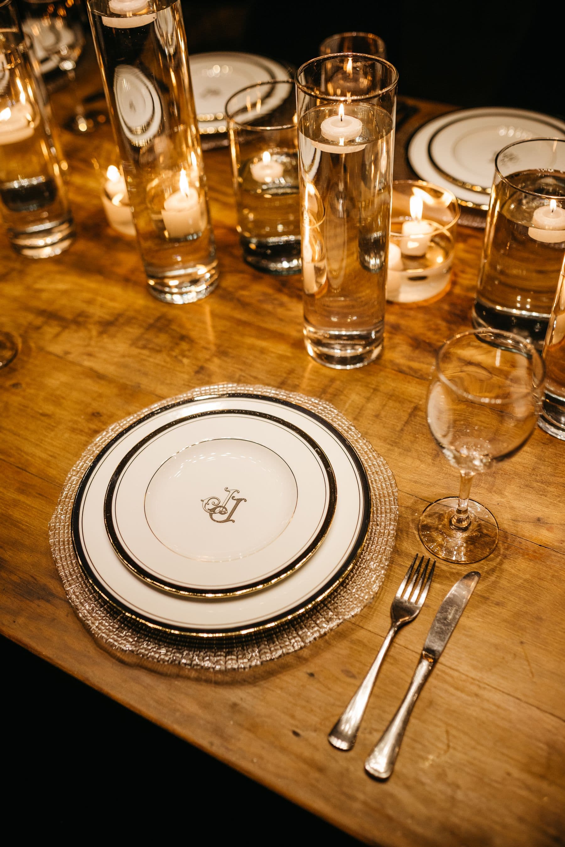 An elegant candlelit place setting with fine china